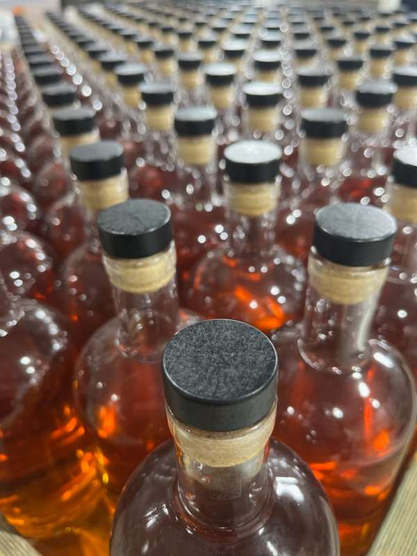 182 Freshly Filled Three Realms bottles of Whisky